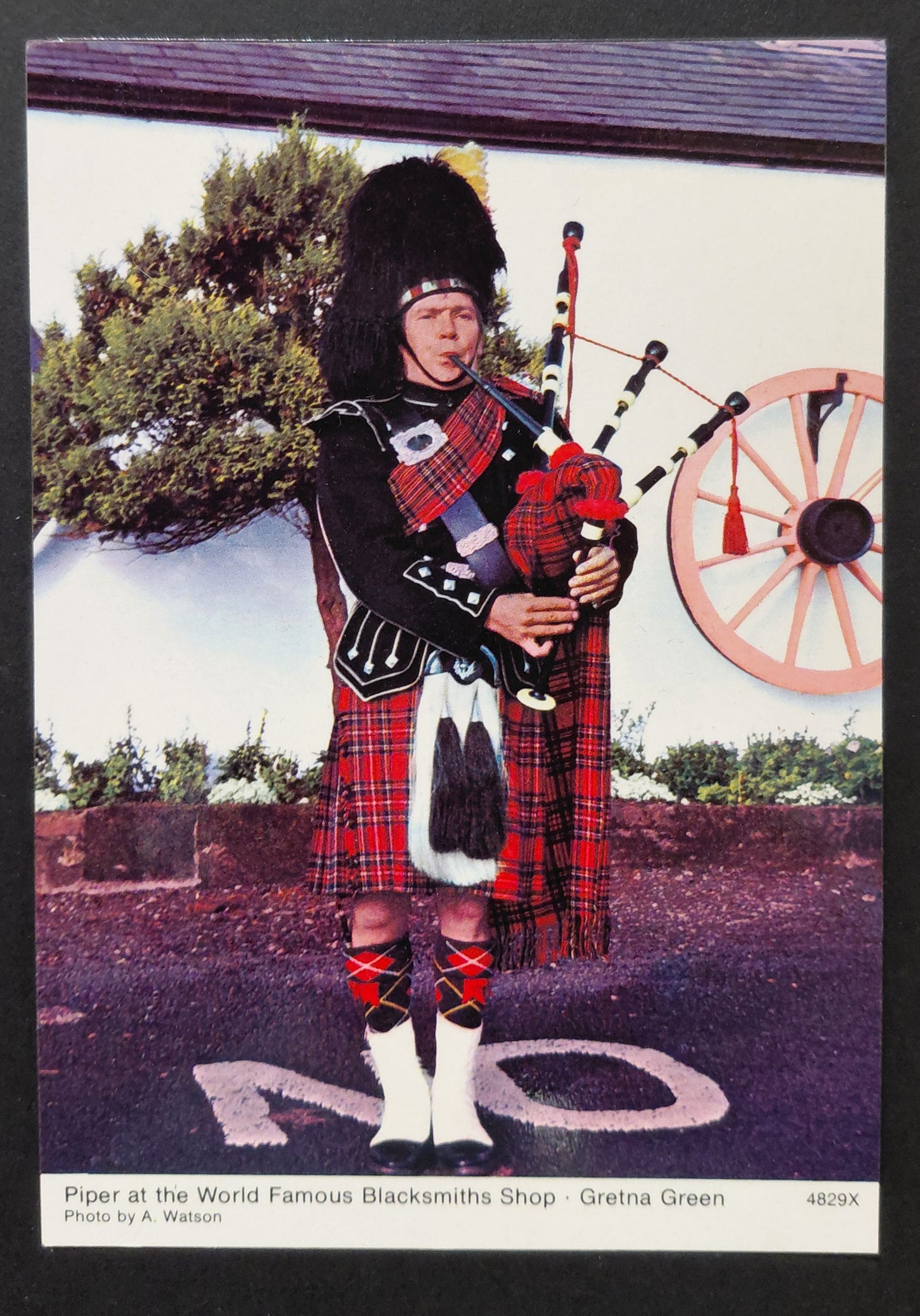 Piper at the Blacksmiths Shop — Gretna Green, Scotland — Vintage Whiteholme Postcard c.1960s–70s